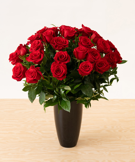Red Roses in Black Glass Vase