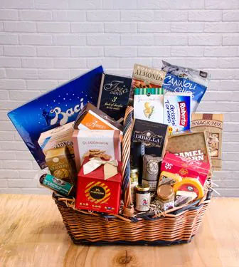 Cheese, coffee, candy and caramel corn in a woven gift basket