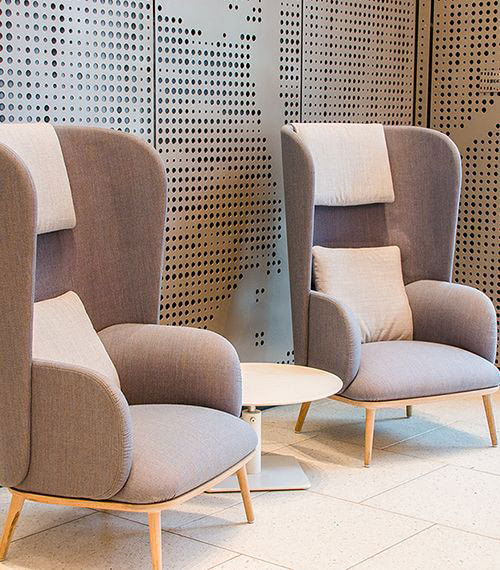 Two plush chairs with a vacant table between them
